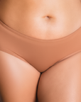 Front view of PROCLAIM Maya medium nude organic cotton mid-rise brief underwear
