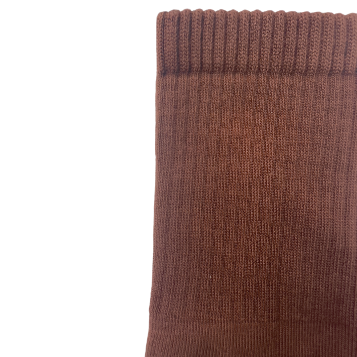 Close up view. a pair of organic pima cotton crew socks that are ethically and sustainably made in Peru. In Ella, a warm brown tone.