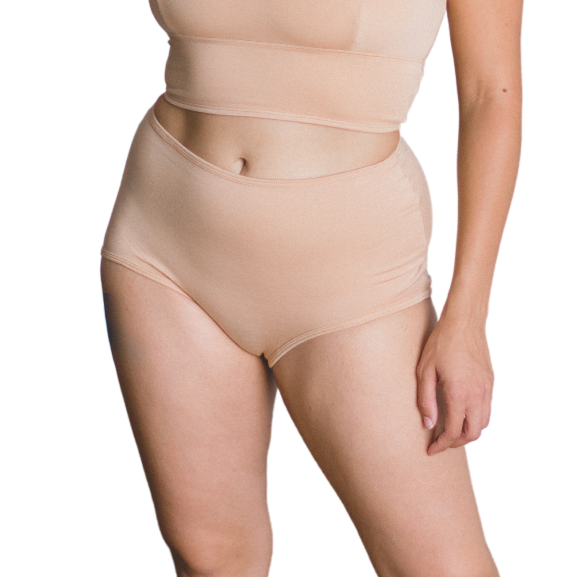 Woman wearing an ada light nude organic cotton high rise brief bottom on a white background