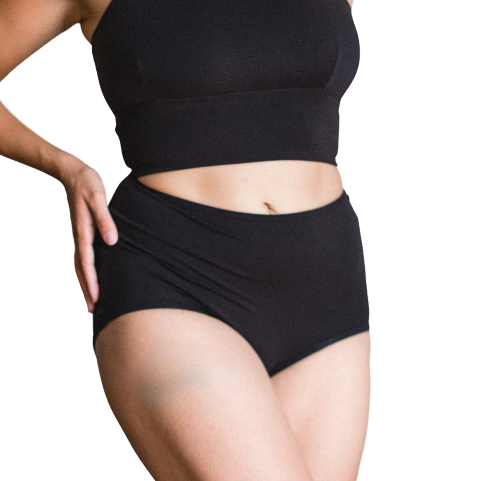 Woman wearing an black high rise organic cotton brief bottom with matching bralette on a white background