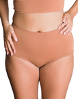 woman wearing proclaim high rise brief underwear in maya medium nude, front view on white backround