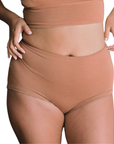 woman wearing proclaim high rise brief underwear in maya medium nude, front view on white backround