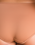 Back view of PROCLAIM Maya medium nude organic cotton mid-rise brief underwear