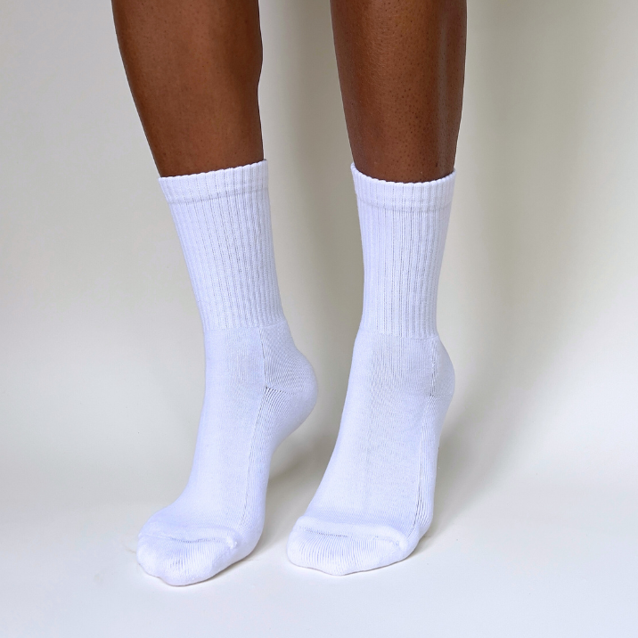 model on toes wearing white crew organic pima cotton socks that are ethically and sustainably made in Peru