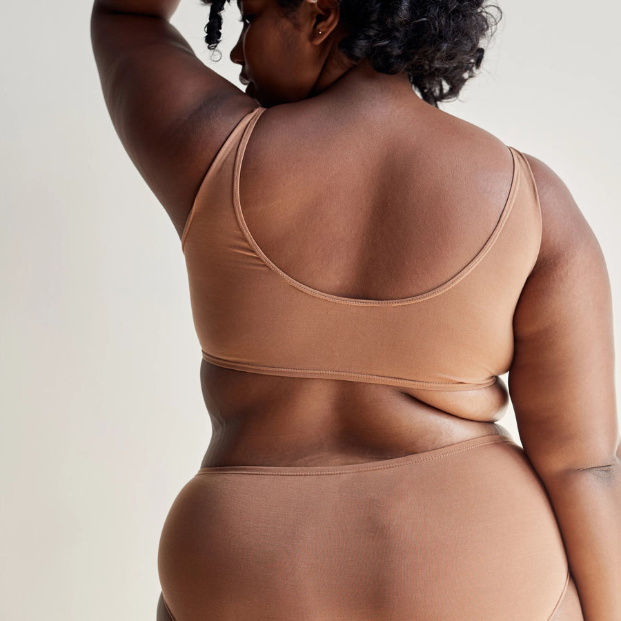 Maya nude bralette from Everyday collection in Tencel fabric, on model with side profile, back view