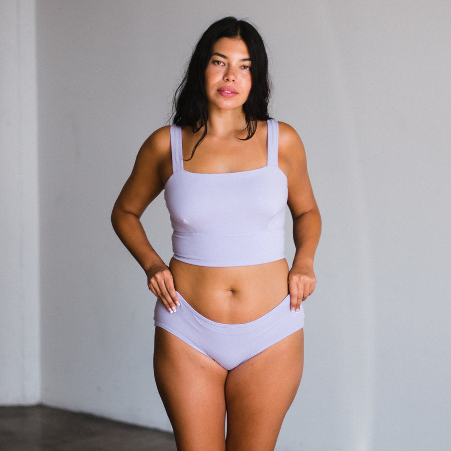 model wears mid rise briefs in lilac light purple made from organic cotton and hemp